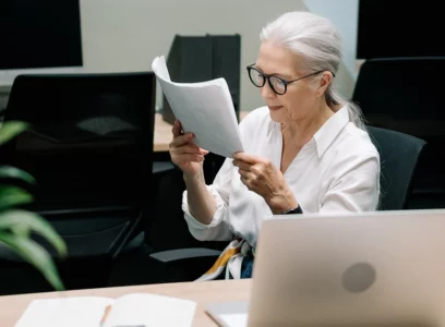 old woman reading a document