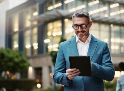 Mature, business and man with tablet outdoor for communication, research and typing email on website. Professional, male manager and digital for networking, contact and task management in urban city