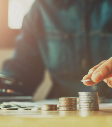 Saving money woman hand putting coin stack concept business finance