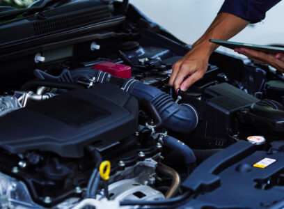 Auto mechanic hands using wrench to repair auto engine. Car maintenance, service at garage. Technician inspects vehicle for problems. Auto repair, fixing, check, services, insurance, checkup concept.