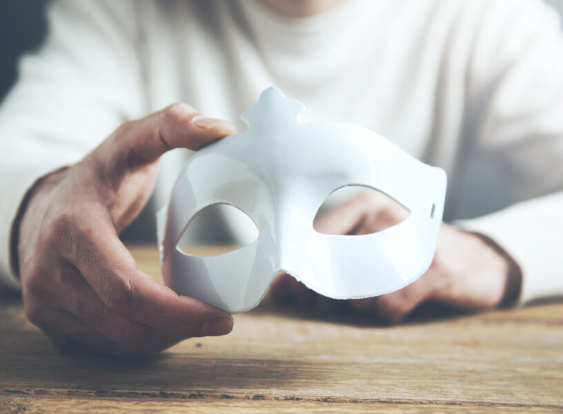 Man hand mask Man hand mask on wooden table background
