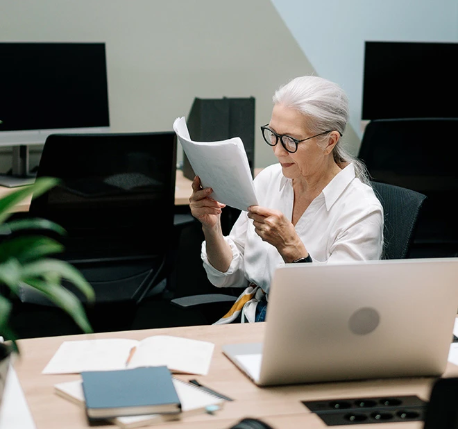 old woman reading a document